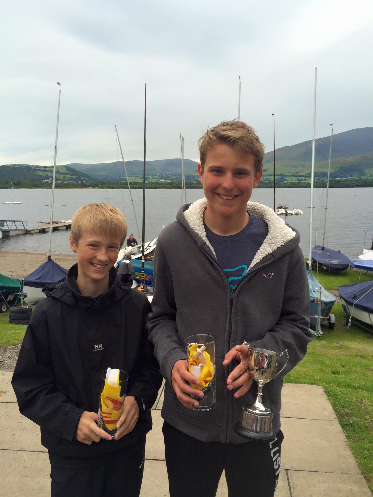 Two teenagers with cup and prizes