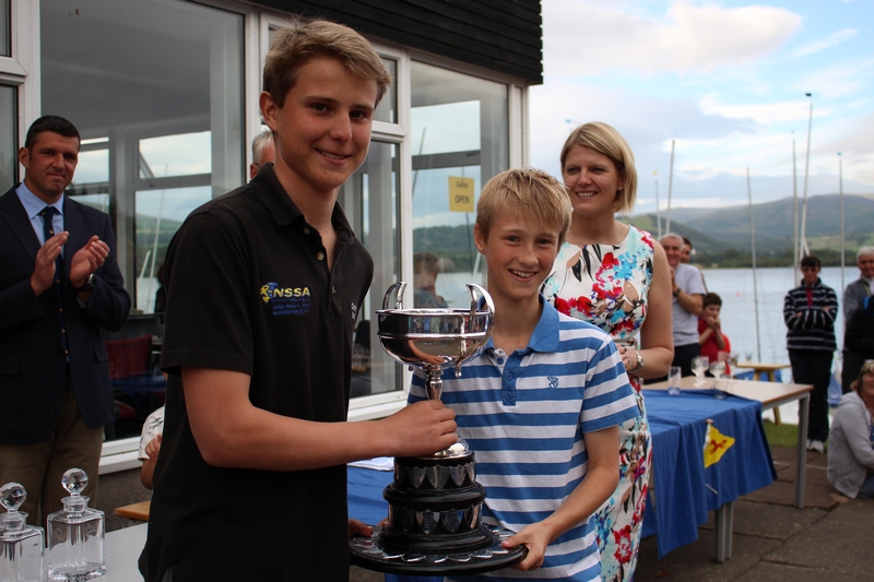 Two young Mirror sailors with a big trophy