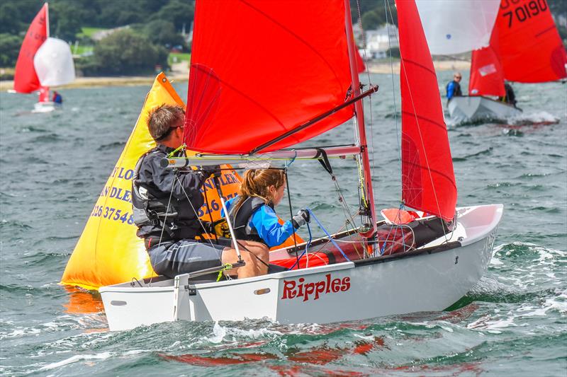  A white GRP Mirror dinghy called 'Ripples' sailing to windward having just rounded the leeward mark