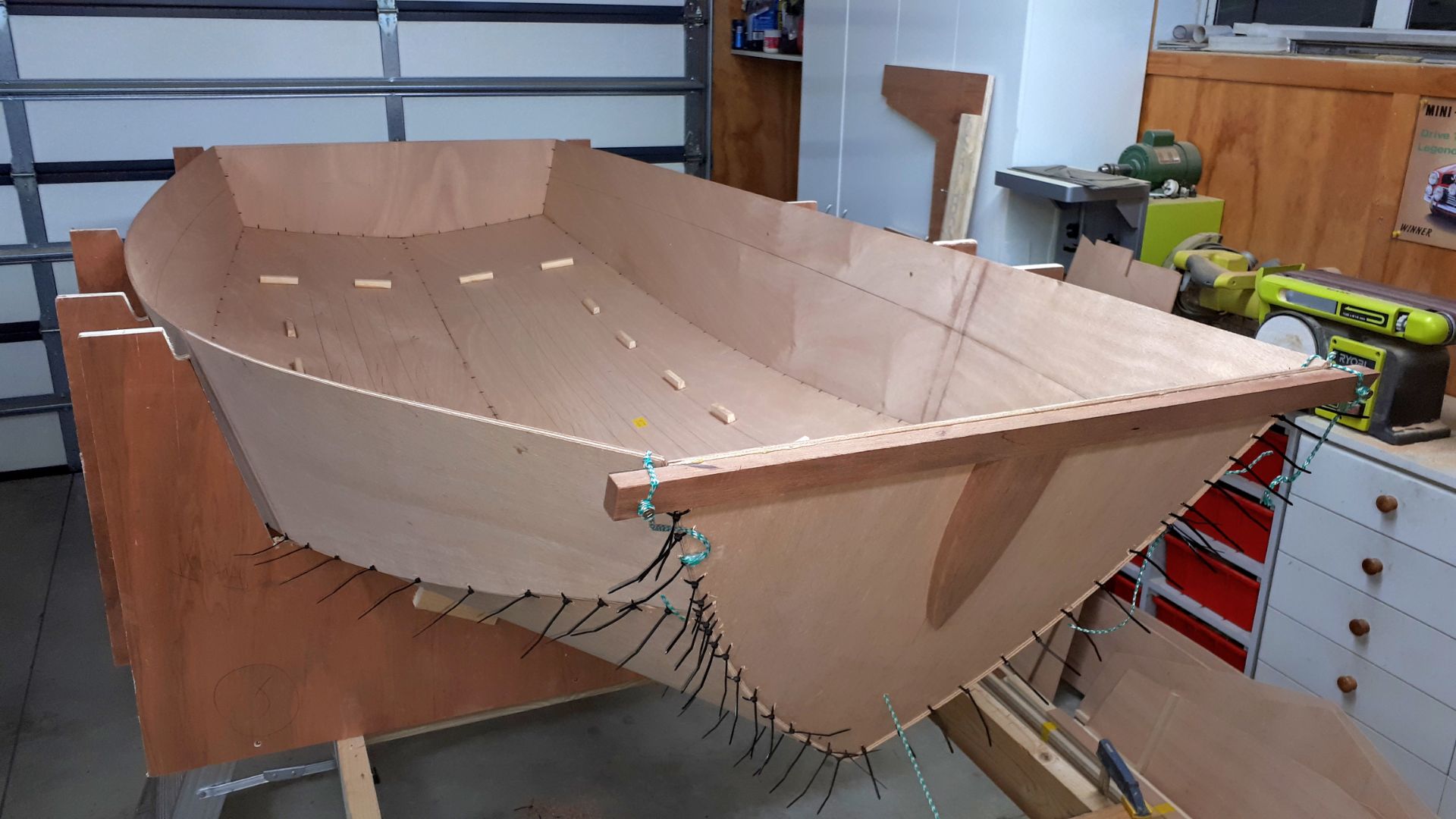 A partly built Mirror dinghy wooden kit being built in a well equipped garage