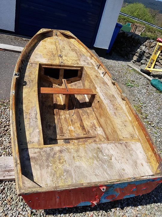 A wooden Mirror dinghy hull in poor condition