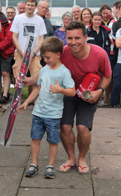 Father and son receiving their prize