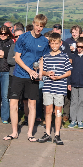An older teenager and younger boy receive their prizes