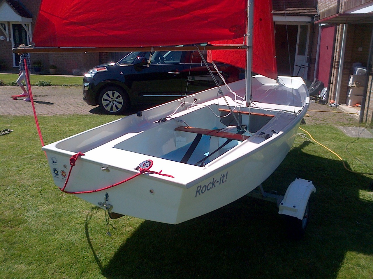What is thought to be a Holt GRP Mirror dinghy rigged up on a lawn