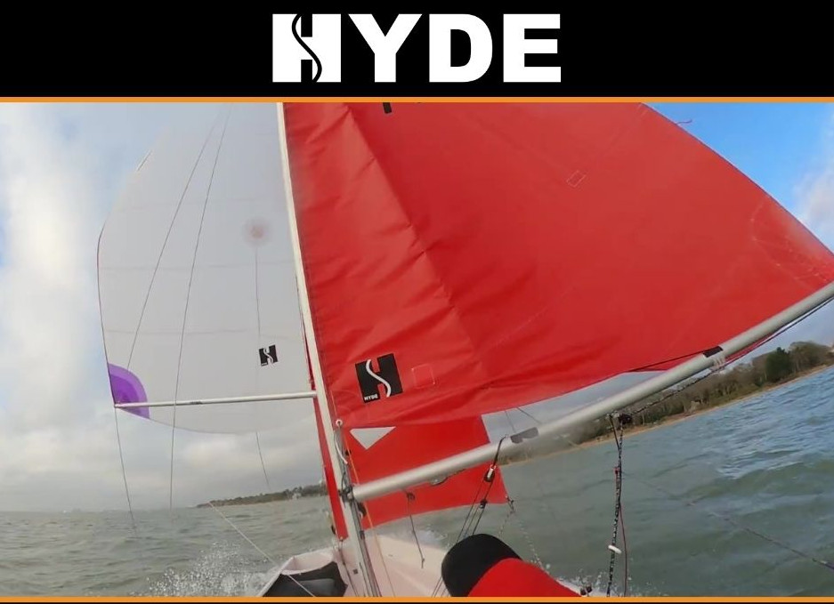 A photo of the spinnaker and mainsail of a Mirror dinghy running downwind taken from the stern