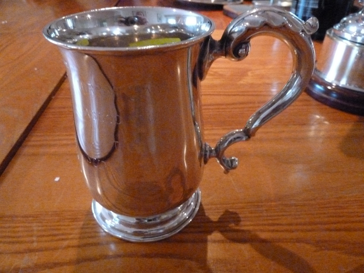 A silver cup with one handle